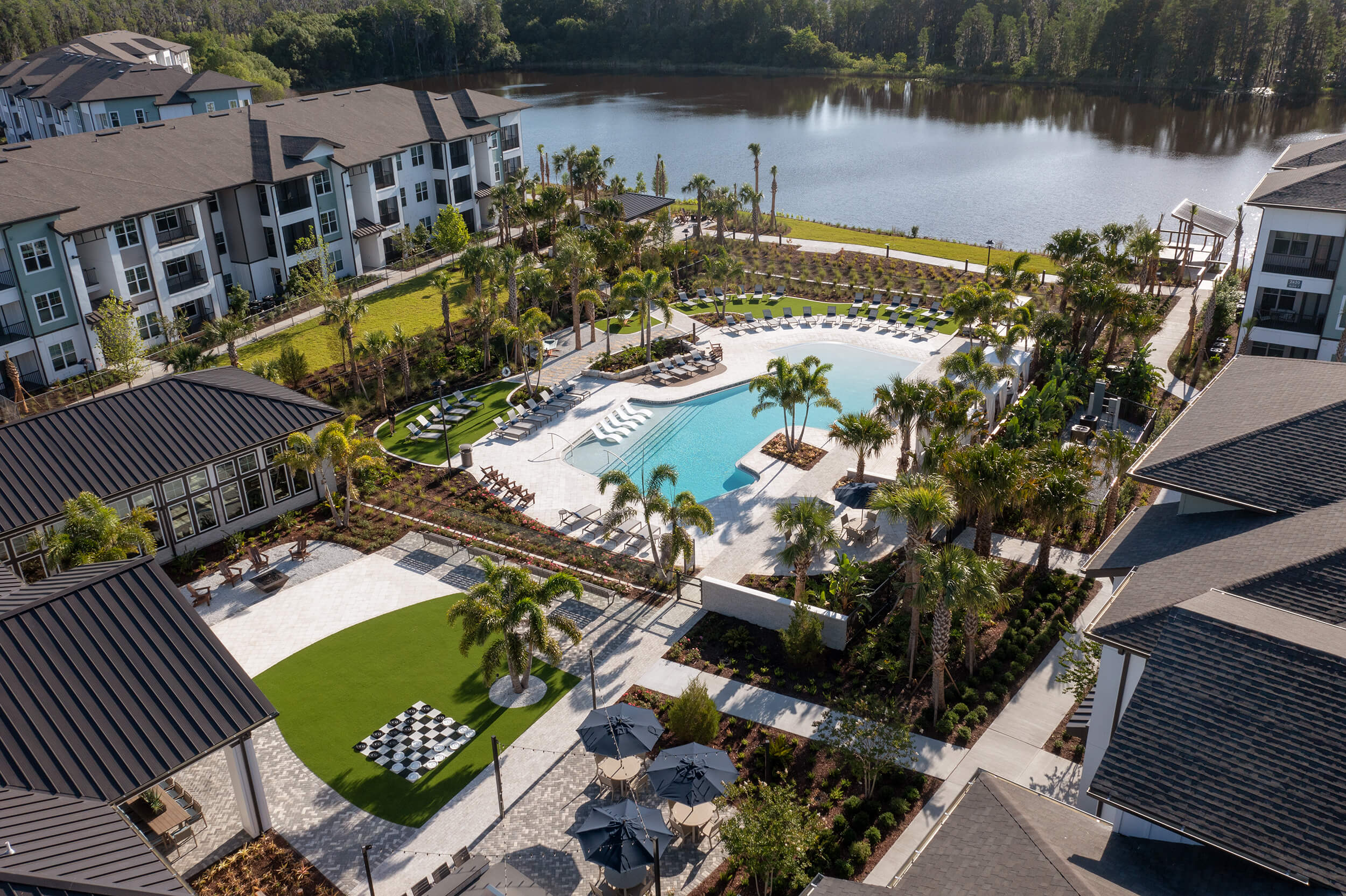 Bainbridge Sunlake aerial of pool area near body of water in between the multistory buildings