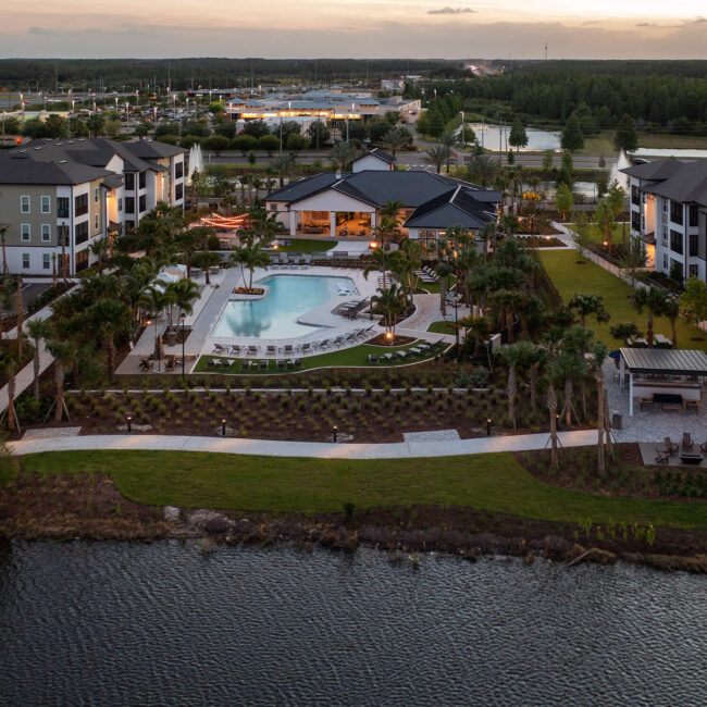 Bainbridge Sunlake aerial of pool area adjacent to multistory buildings and doc near water