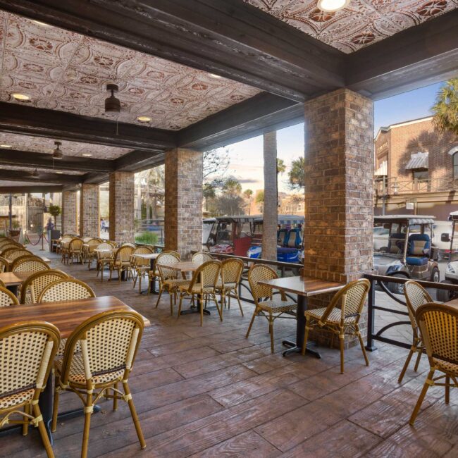 Harvest Restaurant patio dining area with wooden tables and chairs